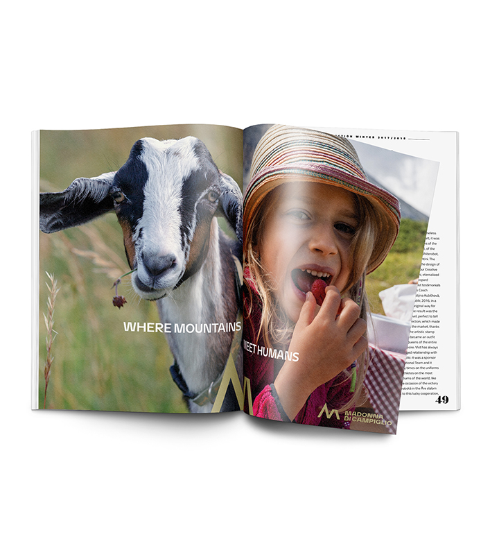 Campagna adv Madonna di Campiglio: "Where mountains meet humans" - bambina che mangia un lampone e capretta che mangia un fiore