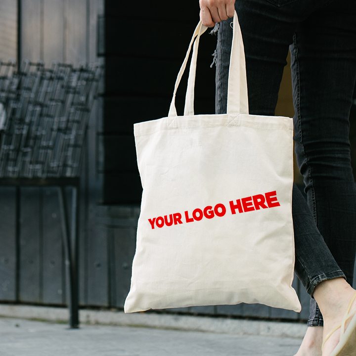 Woman holding white textile bag